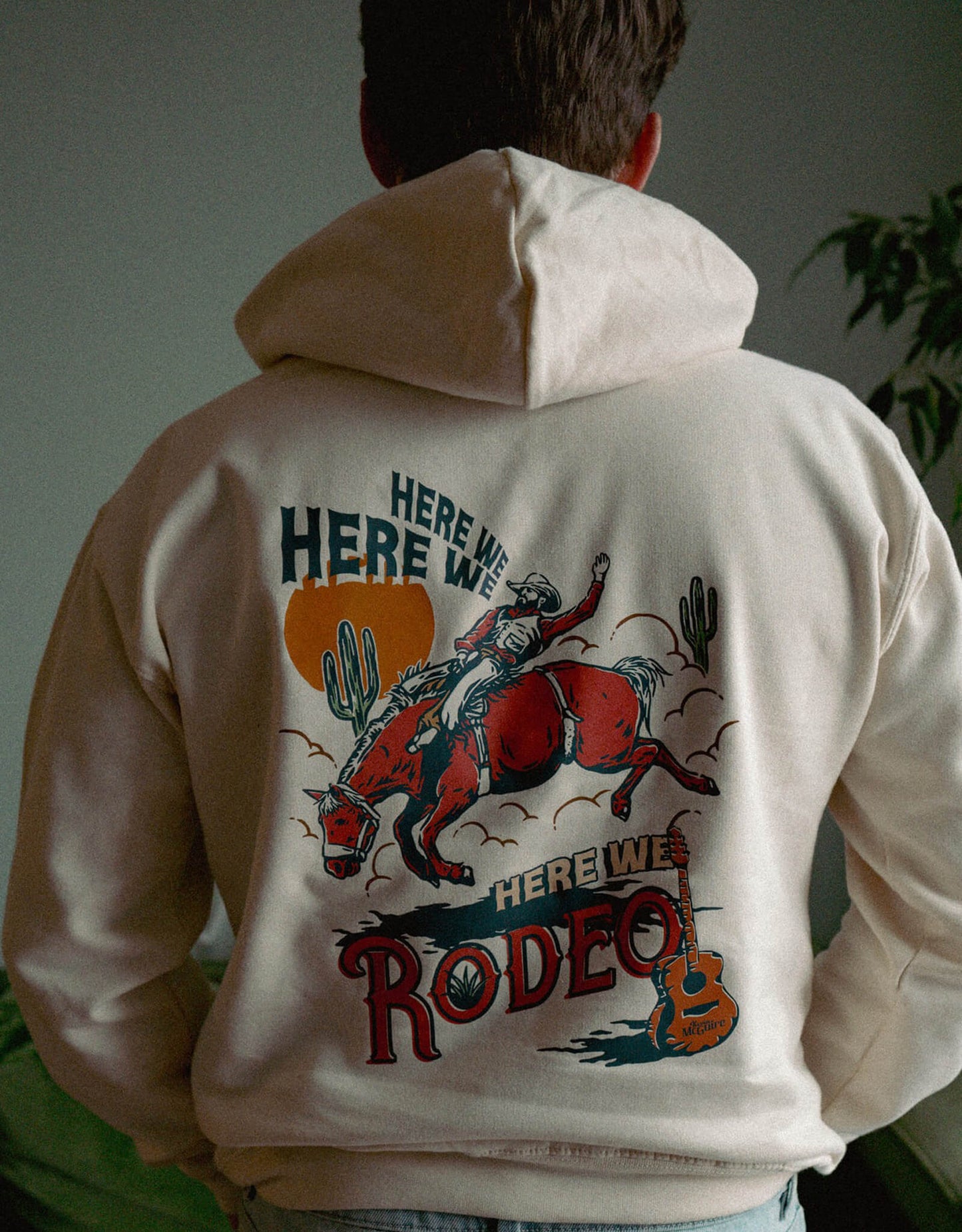 Kevin McGuire wearing his Here We Rodeo Hoodie showing the back print.