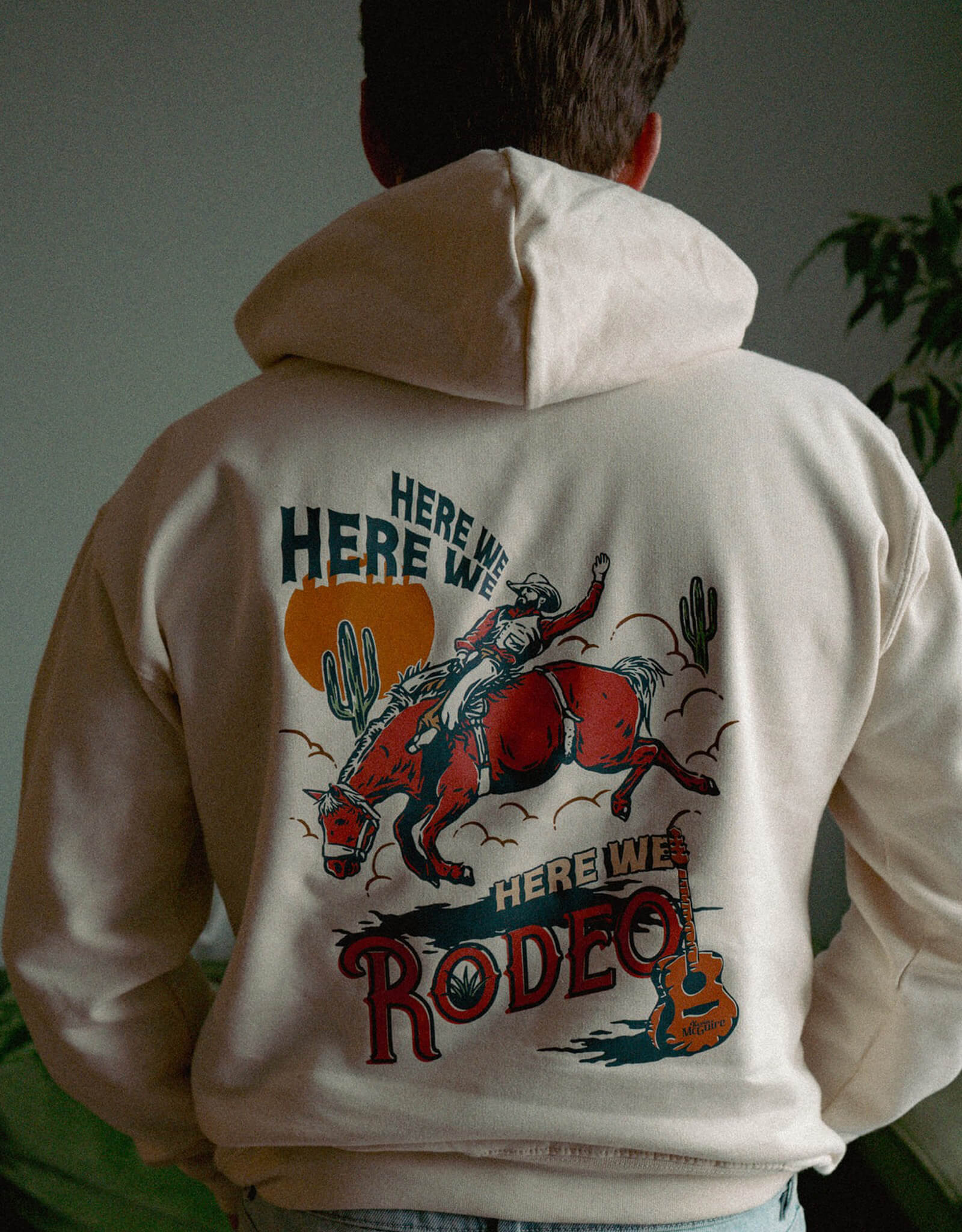 Kevin McGuire wearing his Here We Rodeo Hoodie showing the back print.