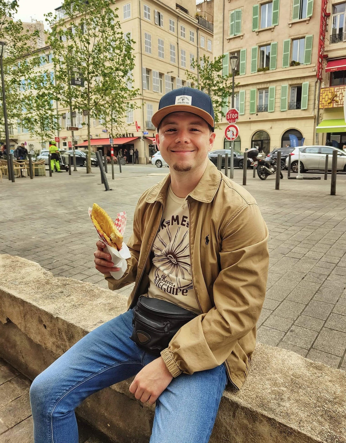 Kevin McGuire wearing Rock Me Mama T-Shirt enjoying street food.