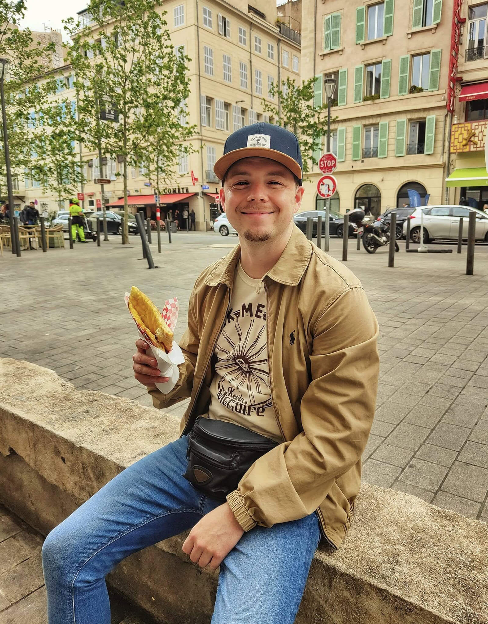Kevin McGuire wearing Rock Me Mama T-Shirt enjoying street food.